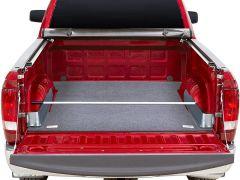 Red pickup truck with open trunk and grey interior.