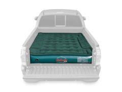 Green inflatable air mattress in a truck bed.