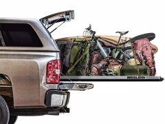 Truck bed with camping gear and bicycle.