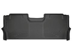 Black rubber vehicle floor mat with embossed patterns for traction, designed to fit the back area of a car.