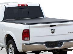 White RAM 4x4 truck with black tonneau cover.