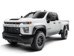 A white Chevrolet Silverado 2500 HD pickup truck with a black grille and rugged tires, angled to show both the front and side.