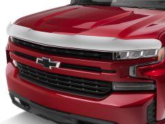 Front view of a red Chevrolet truck with a chrome hood protector and a black grille, featuring the Chevrolet logo.