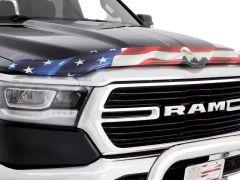 A black truck hood featuring an American flag graphic with a bald eagle, highlighting the RAM logo on the grille.