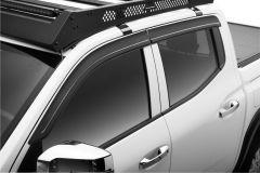 Close-up of a white pickup truck's windows and roof rack, highlighting chrome trims and a black accessory mounted on top.