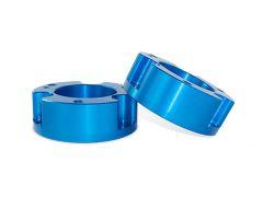 Two polished blue aluminum spacers, one leaning against the other, showcasing smooth surfaces and multiple mounting holes.