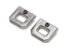 Two metallic, square-shaped lock washers with central holes and screw fittings, placed at an angle on a white background.