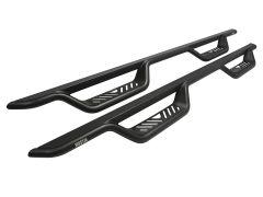 A pair of black metallic vehicle side steps with an elongated design, featuring cut-out traction patterns and the brand name "WESTIN" in red.