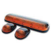 Three amber vehicle lights: one long rectangular light bar and two rounded lights, all with black bases.