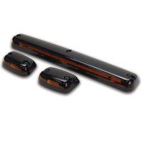 Three glossy black vehicle lights: one long rectangular light in the center and two smaller rounded lights on either side, all featuring amber lenses.