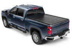 A blue Chevrolet Silverado 2500 HD pickup truck from a high angle, showcasing its rear, side, and covered truck bed.