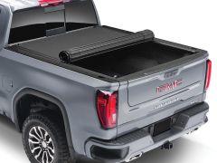 Gray GMC Sierra truck with black tonneau cover.