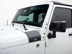 White Jeep Wrangler with black accents and soft top.