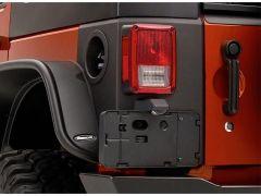Close-up of Jeep's red and black tail light and door handle.