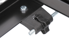 Close-up of a metal clamp with screw and knob.
