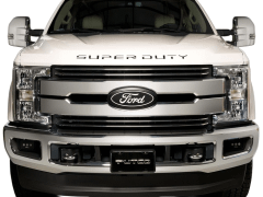 Front view of a white Ford Super Duty truck featuring a chrome grille, illuminated headlights, and the "SUPER DUTY" inscription above the grille against a white background.