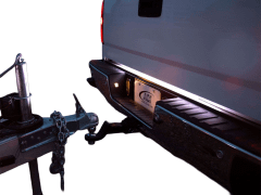 Truck hitch with illuminated license plate on a white background.