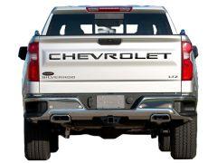 Rear view of a silver Chevrolet Silverado LTZ pickup truck displaying the brand name and model on the tailgate, parked on a white background.