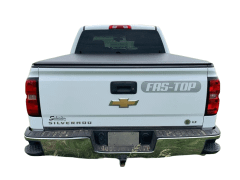 White Chevrolet Silverado truck in a field.