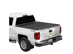 Rear view of a white Chevrolet Silverado truck with a black retractable bed cover, showcasing a sleek design with a prominent Chevrolet logo on the tailgate.