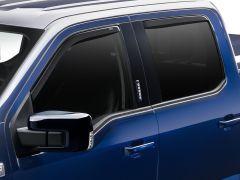Blue truck with tinted windows and side mirror.