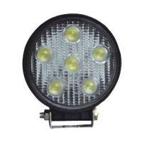 A circular LED light with six yellow bulbs in two rows, mounted on a black casing.