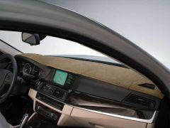 Car dashboard with tan sunshade and navigation screen.