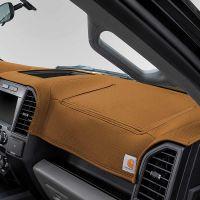 Car dashboard covered with brown Carhartt cover.