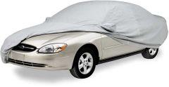 Car covered with gray protective cover on white background.