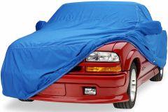 Red car partially covered with blue protective cover.
