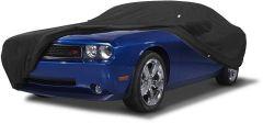 Blue car covered with black protective cover.
