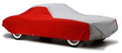 Car covered with red and gray protective cover.