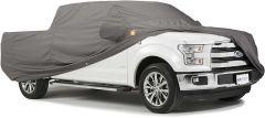 White Ford truck with gray car cover.