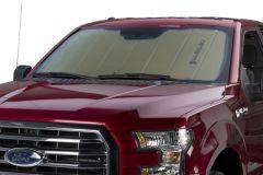 Red Ford F-150 truck with sunshade on windshield.