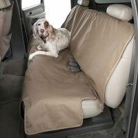 Dog lying on car seat cover in back of vehicle.