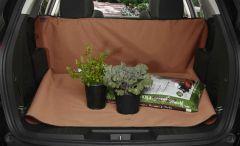 Car truck with brown protector, two potted plants, and gardening soil.