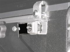 Close-up view of a metallic connector and track mechanism with bolts and smooth finishes.
