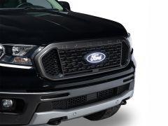 Front view of a black Ford Ranger pickup truck with a honeycomb grille and illuminated Ford logo.