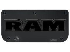 Black license plate cover with bold "RAM" lettering in shiny black. Features small alligator logo in the corner.
