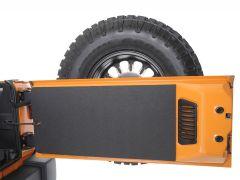 Open tailgate of an orange vehicle with a mounted Good Year tire behind it.