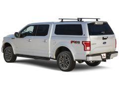 Silver Ford F-150 truck with a cargo cap and crossbars, displaying the "FX4" logo on the rear.