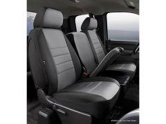 Interior of a vehicle showing three gray, fabric-covered front seats. The center seat folded down, revealing a console.