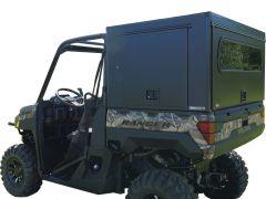 Side view of a Polaris Ranger all-terrain vehicle with a camouflage side and a matte black cargo box, large off-road tires, and an open cabin.