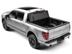 Silver Ford F-150 pickup truck with open tonneau cover.