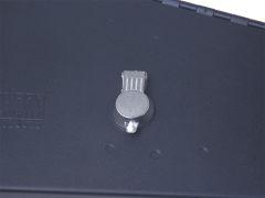Close-up of a secure metal lock mechanism on a dark matte surface.