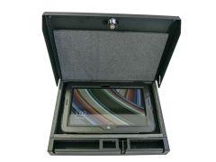 Tablet securely placed inside a foam-lined, black lockbox. The device's screen displays a colorful abstract design.