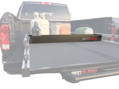 Truck bed with Bed Slide storage system and camping gear.